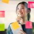 Young confident Businesswoman planning with adhesive notes in creative office.